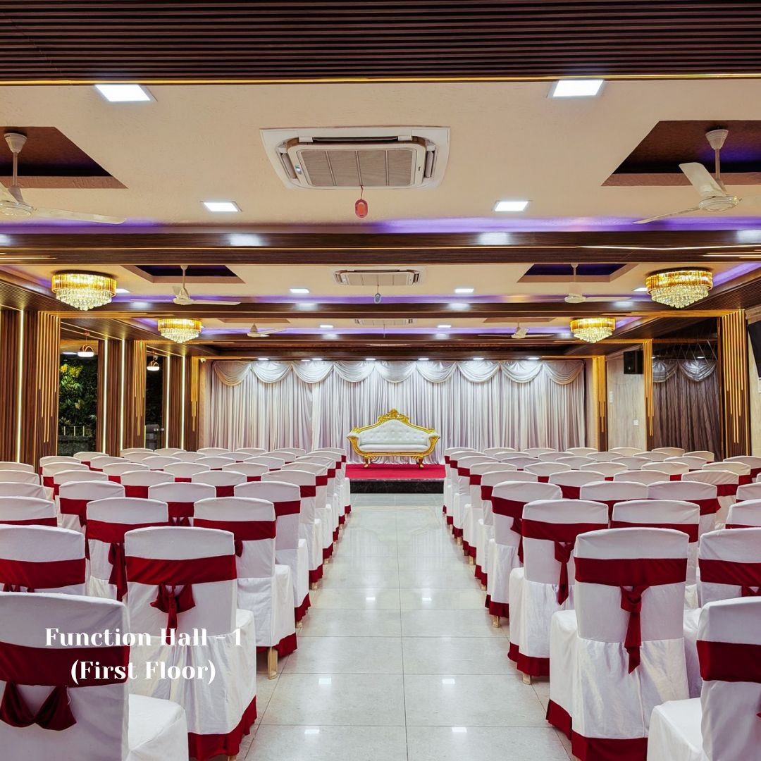 Function Hall 1 on the first floor with maroon-sashed seating and stage
